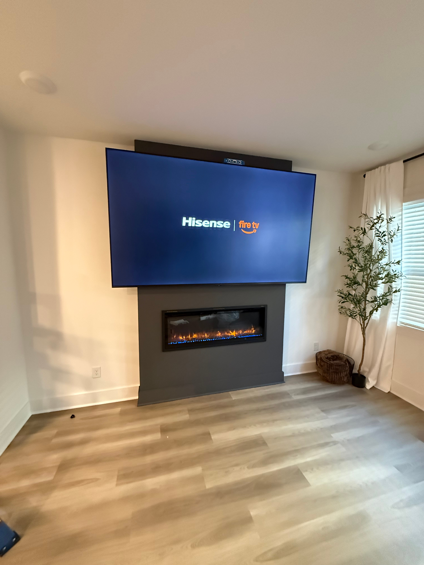 TV mounted with professional in-wall wire concealment above fireplace in Atlanta, GA