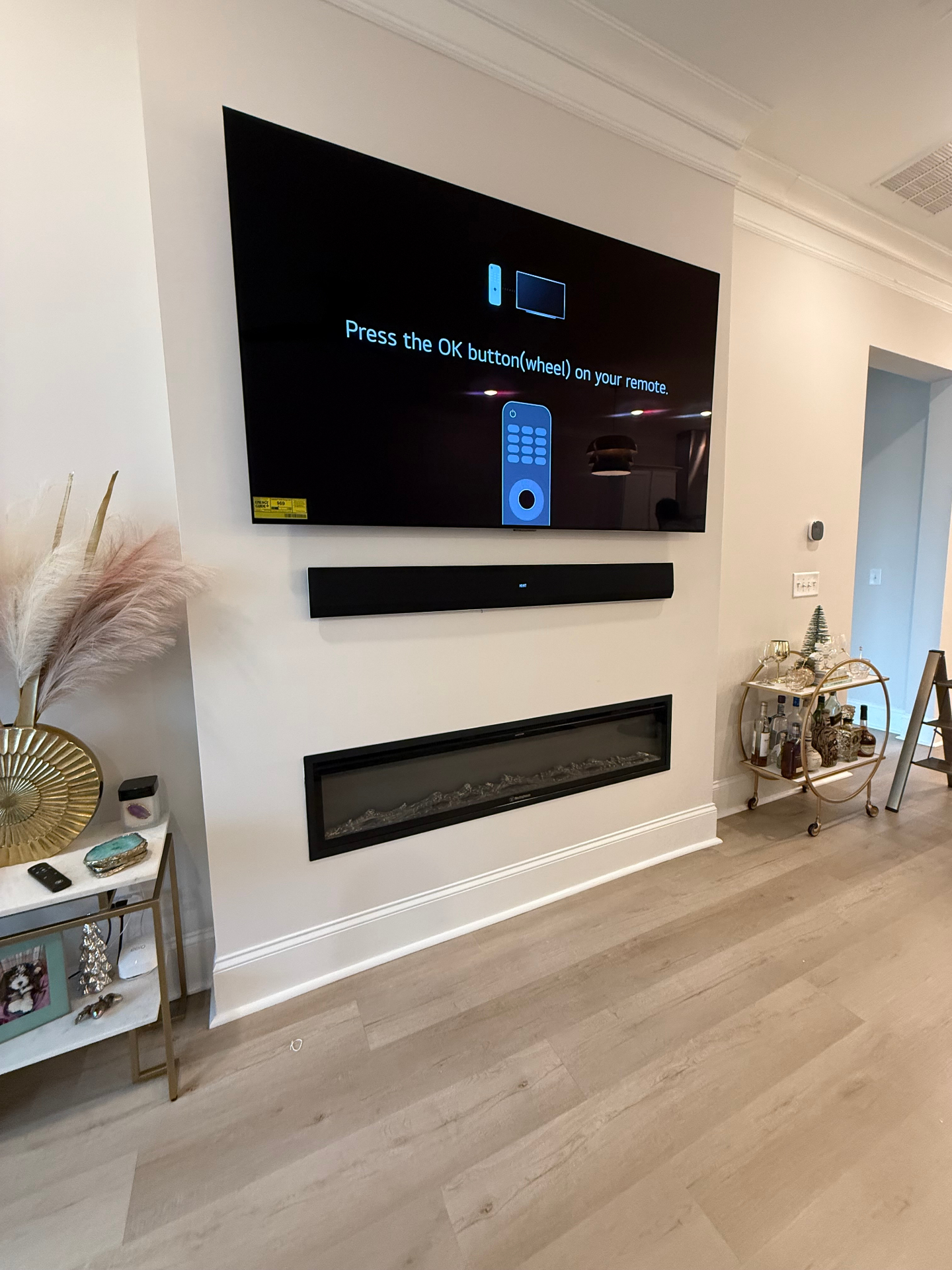 75-inch TV with soundbar mounted above fireplace in Buford, GA living room