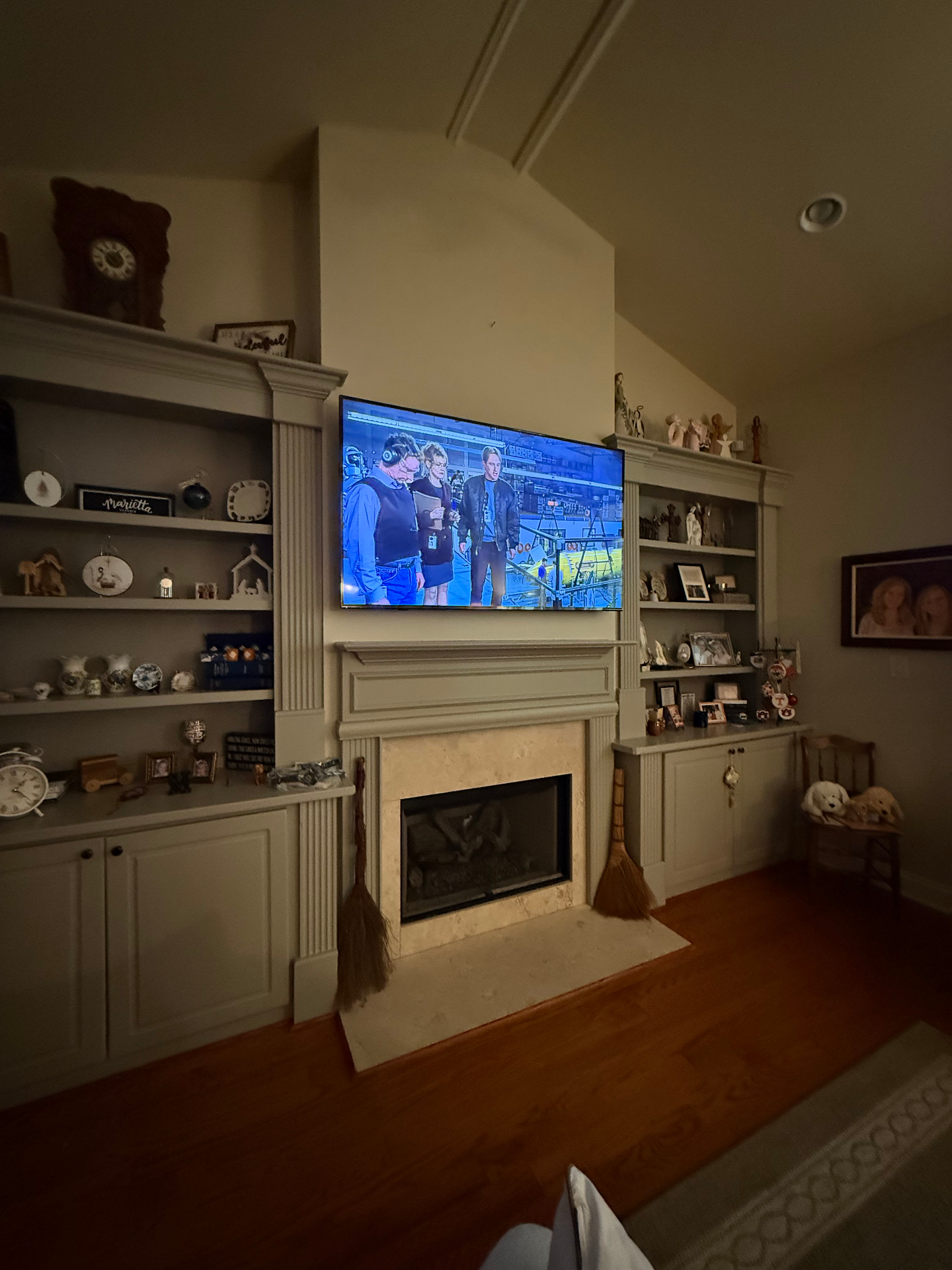 70-inch TV mounted above fireplace in Duluth, GA with recessed outlet and tilt mount