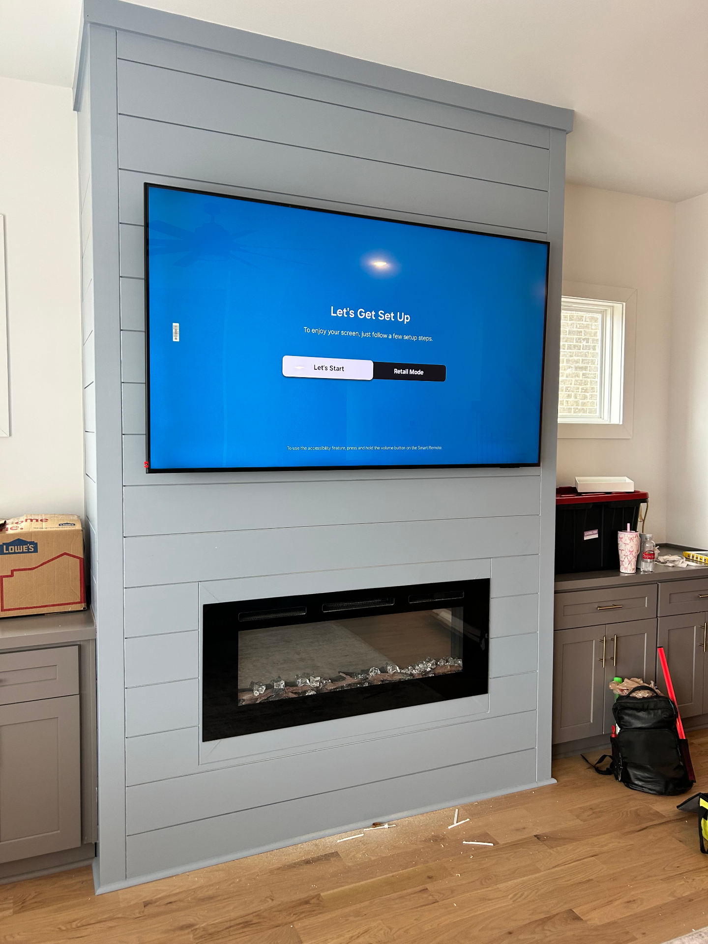 65-inch TV mounted above shiplap fireplace mantel in Johns Creek, GA