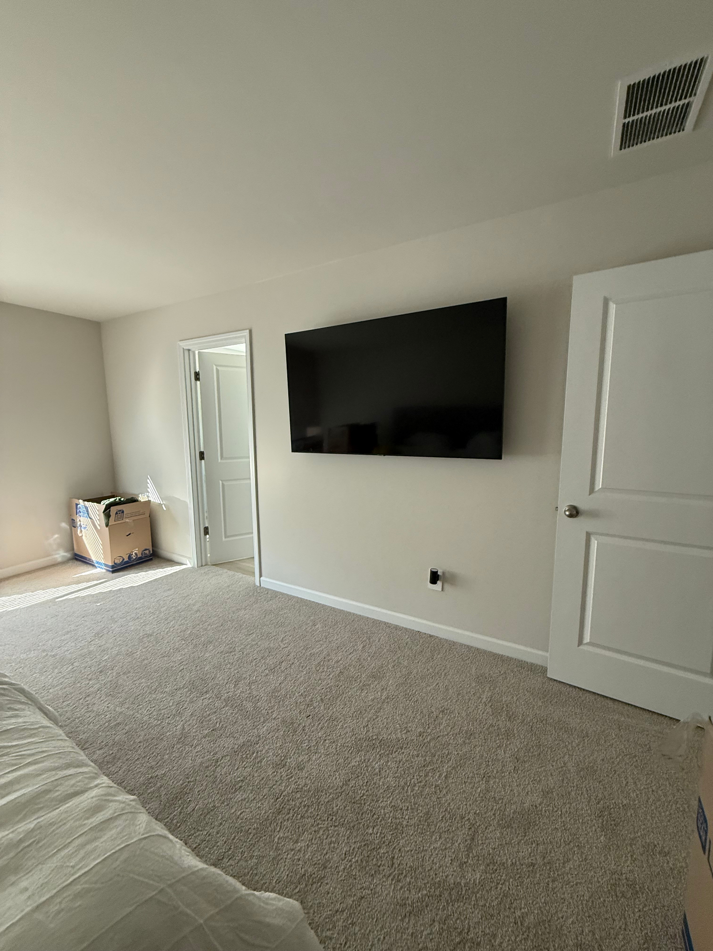 Bedroom TV mounted with professional wire hiding and cord cover in Mableton, GA