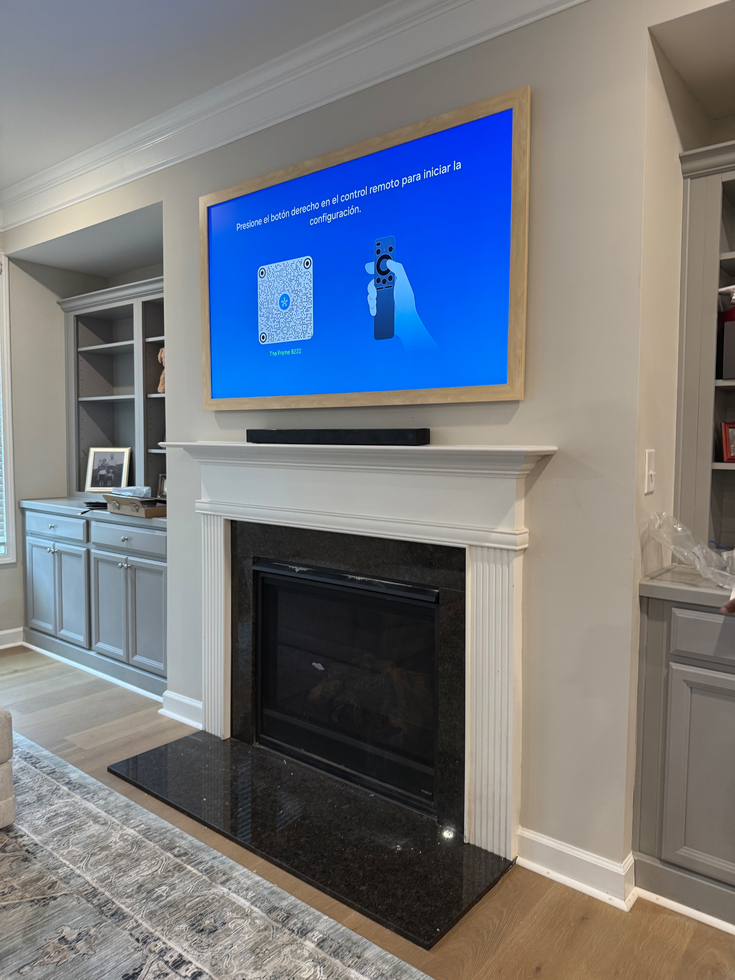 65-inch Samsung Frame TV mounted above fireplace in Marietta, GA with One Connect box and soundbar wires concealed behind the wall