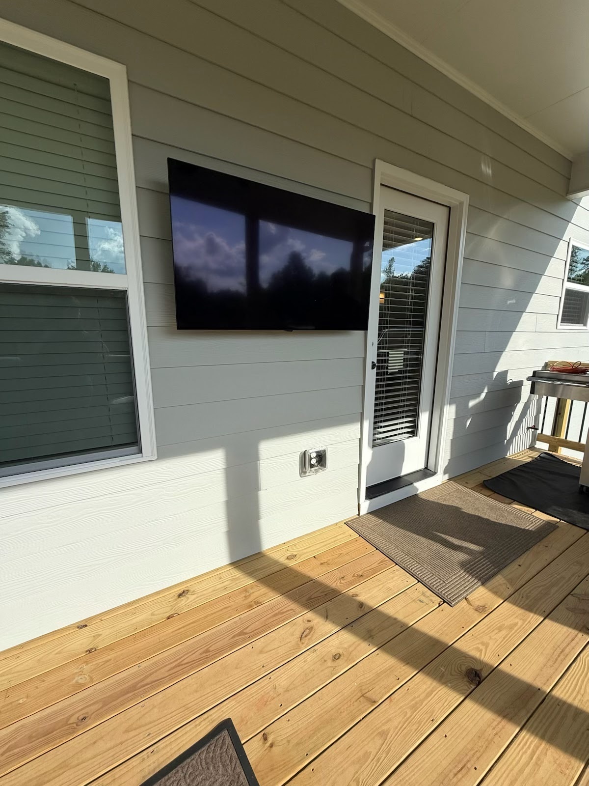 Outdoor TV mounted on deck with full-motion swivel mount in Sugar Hill, GA