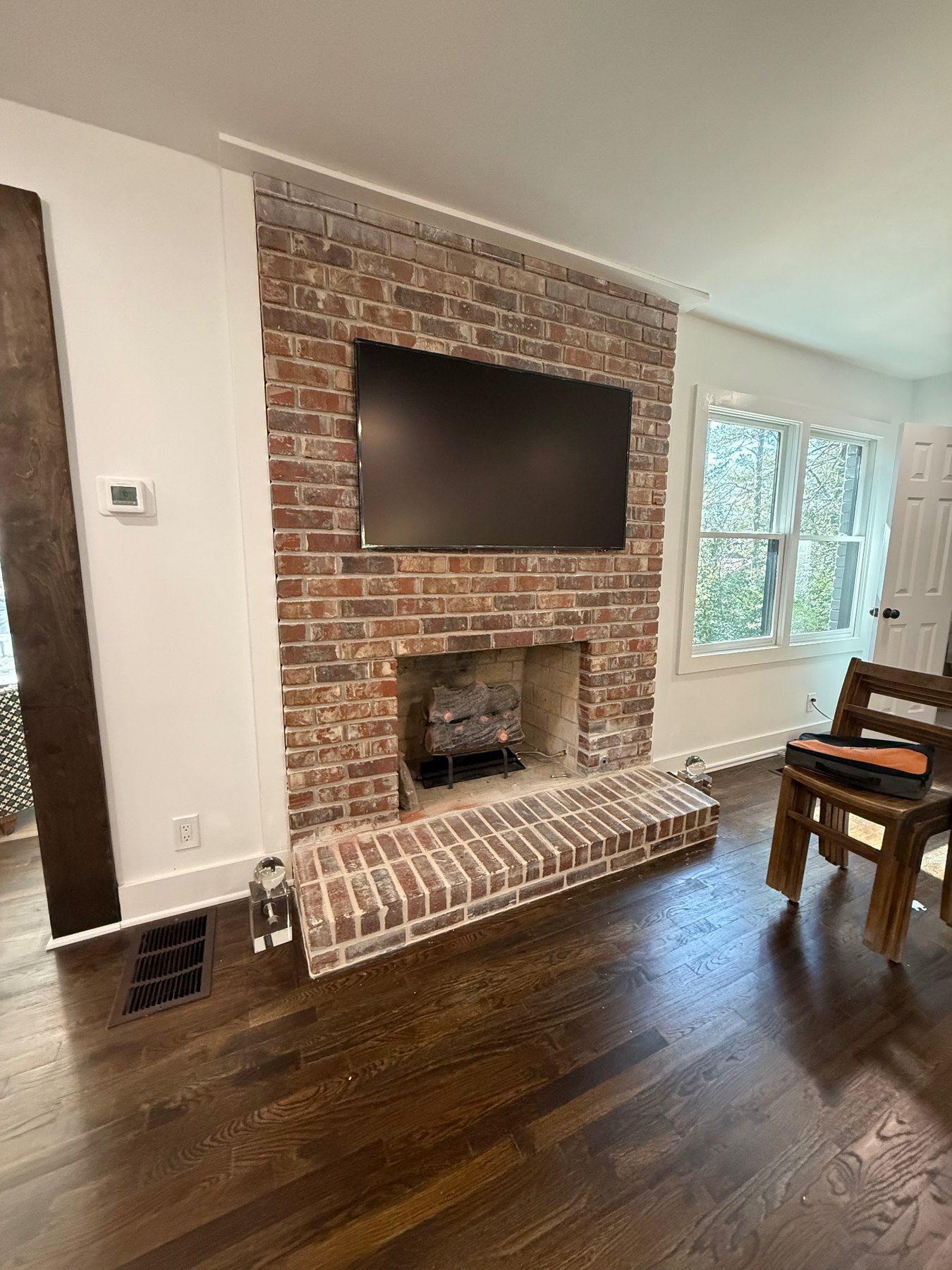 Samsung Frame TV mounted above a brick fireplace with professional masonry mounting in Metro Atlanta