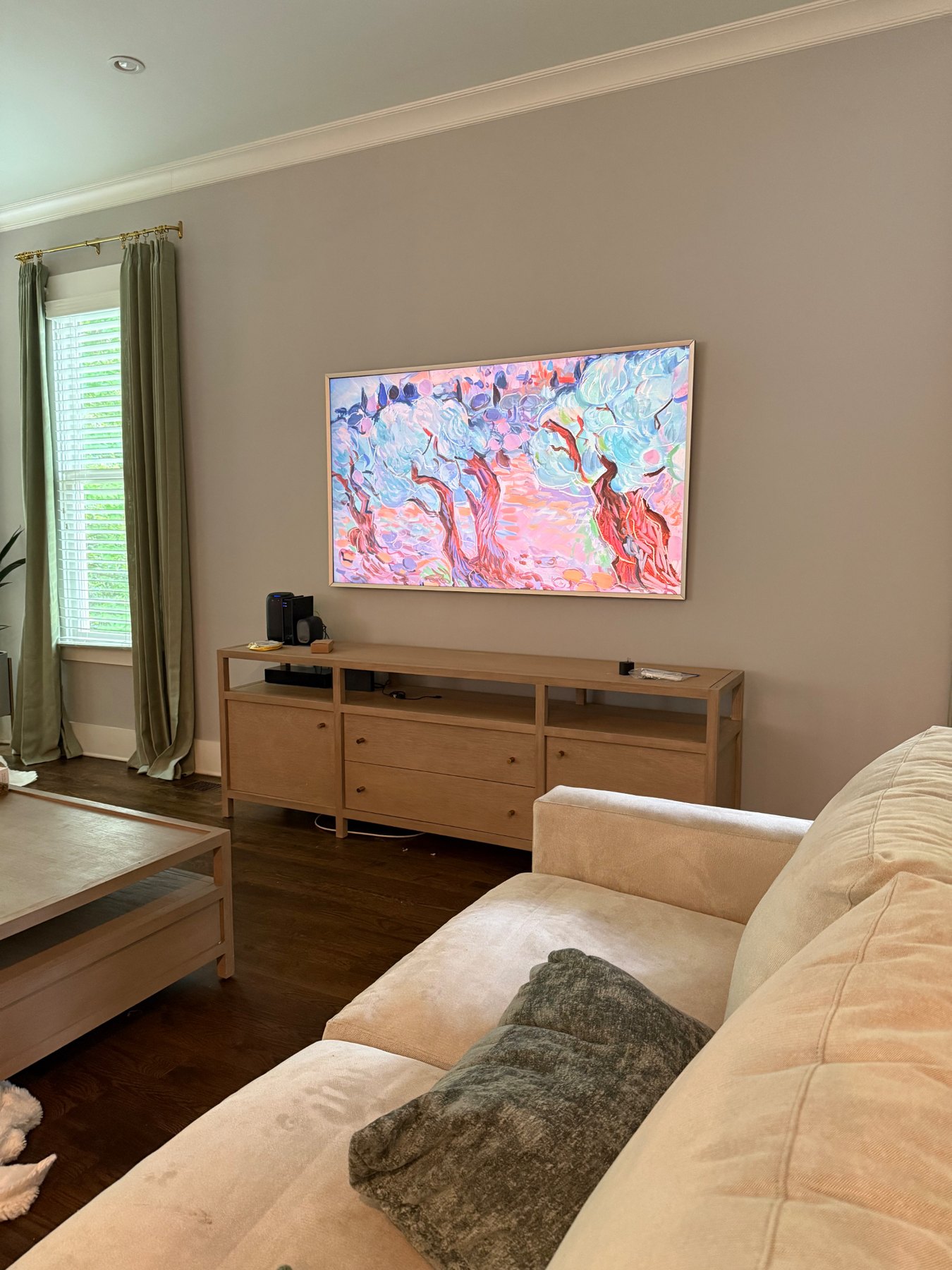 Samsung Frame TV mounted in a living room displaying artwork with a slim frame and clean installation