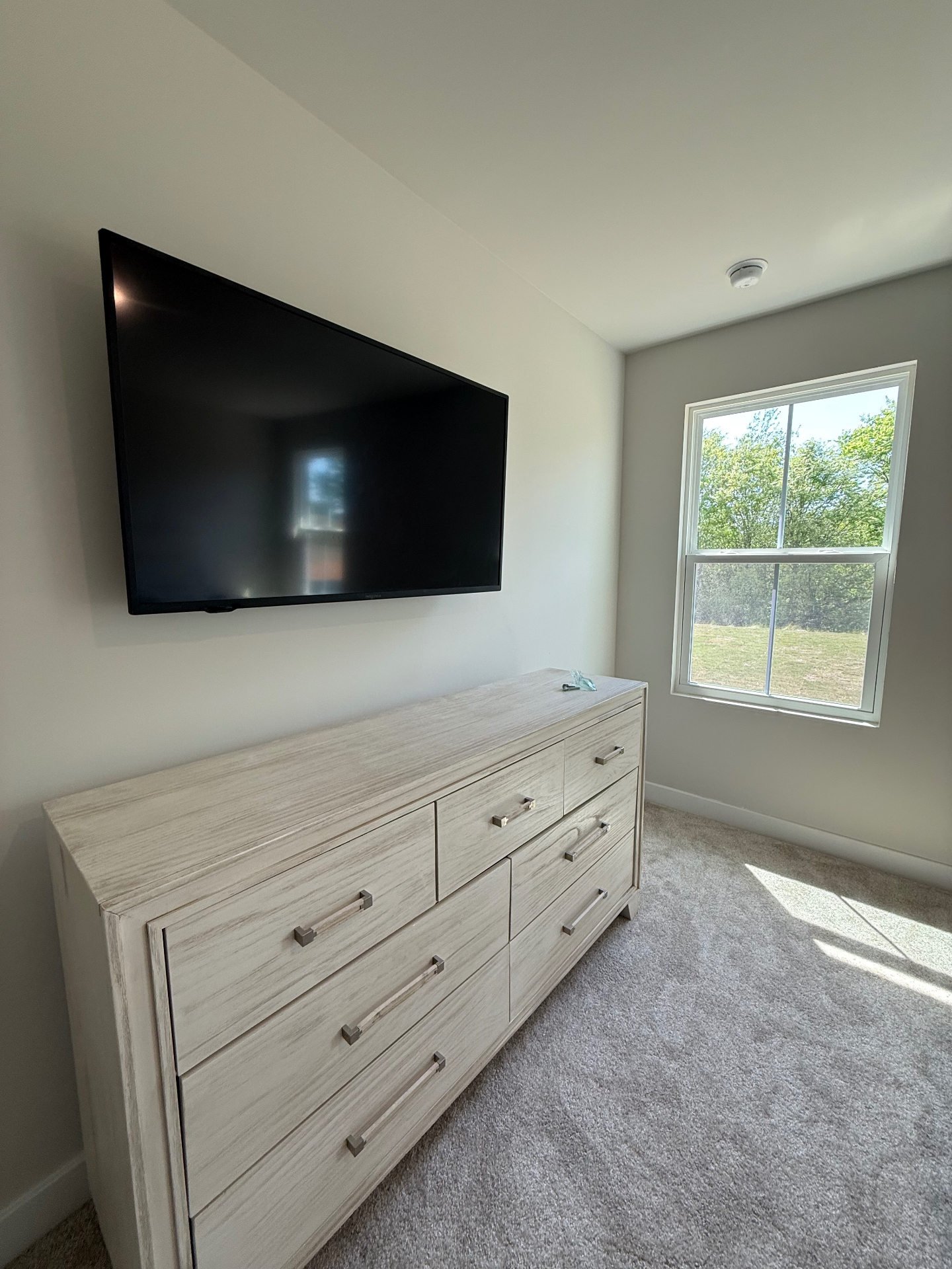 55-inch TV mounted on bedroom drywall in Calhoun, GA