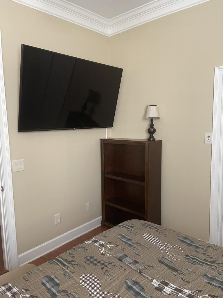 Can one person hang a TV on the wall?