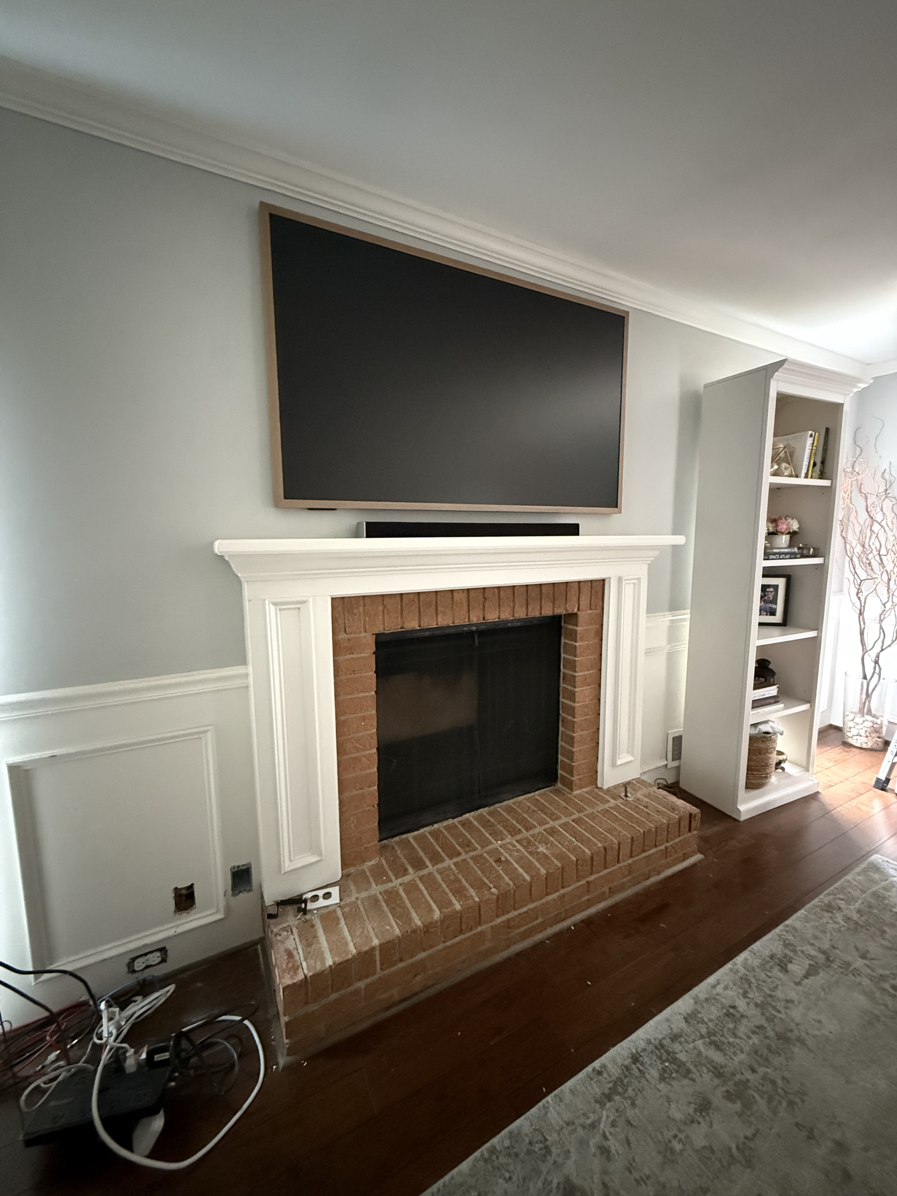 Frame TV over fireplace with hidden wires